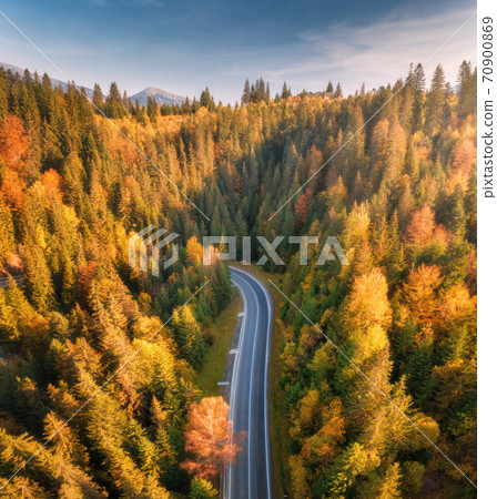 Aerial view of mountain road in forest at sunset in autumn Aerial view of mountain road in forest at sunset in autumn 70900869