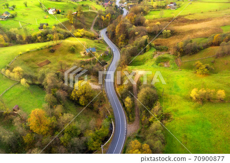 Aerial view of beautiful winding road in green hills 70900877