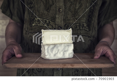 Craft cheese from cows and goats milk. Cheese head. Crottin Craft cheese from cows and goats milk. Cheese head. Crottin 70901903