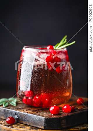 Festive Cranberry and rosemary cocktail with ice. Alcoholic or non-alcoholic cocktail Festive Cranberry and rosemary cocktail with ice. Alcoholic or non-alcoholic cocktail 70902698