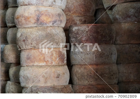 Fresh cheese on rack in factory warehouse.  70902809