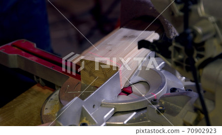 Carpenter uses Circular Saw with laser Cutting wooden beams. Close-up Carpenter uses Circular Saw with laser Cutting wooden beams. Close-up 70902923
