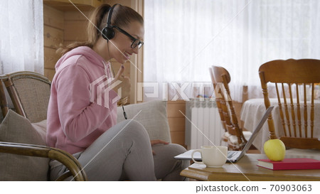 Woman holds workshop from home and communicates with colleagues per Internet. 70903063