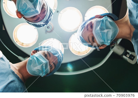 Image of medical staff performing surgery Image of medical staff performing surgery 70903976