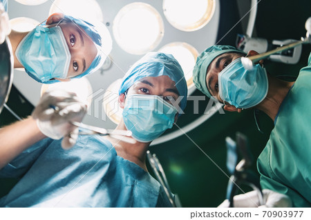 Image of medical staff performing surgery Image of medical staff performing surgery 70903977