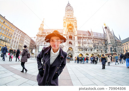 Woman Tourists selfie near the  Marienplatz town hall and Frauenkirche in Munich, Germany 70904806