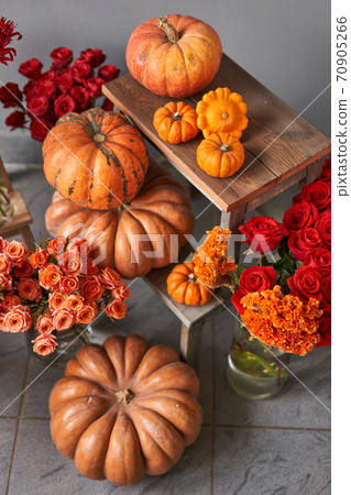 Autumn mood. Set of pumpkins and orange and red flowers for Interior decorations. The work of the florist at a flower shop. Fresh cut flower. 70905266