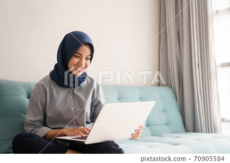 portrait of beautiful muslim woman who is very happy to see the results of her efforts portrait of beautiful muslim woman who is very happy to see the results of her efforts 70905584