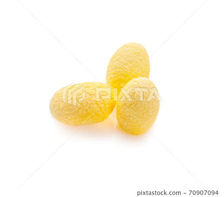 yellow thai silkworm cocoons pile isolated on white background 70907094
