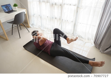 asian man sitting up workout from home 70907727