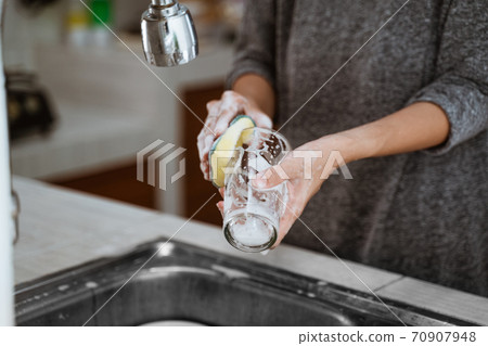 woman is washing dishes 70907948