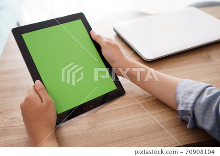portrait a hand holding a digital tablet with a blank screen portrait a hand holding a digital tablet with a blank screen 70908104