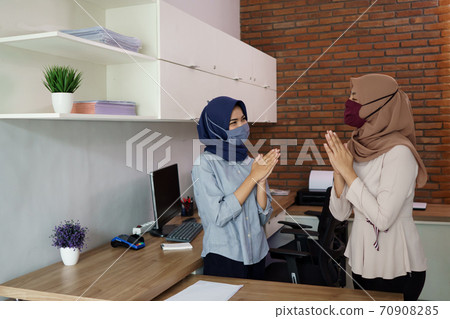 portrait of a beautiful muslim starting a business, a woman greeting her work partner 70908285