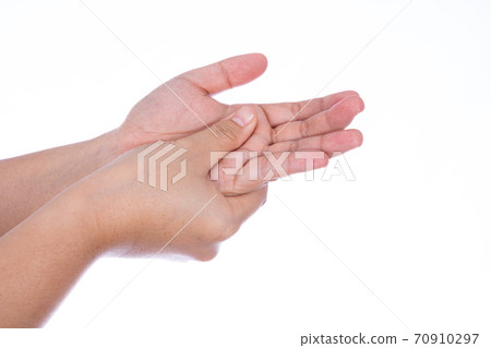 Man hand massaging her hand isolated white background. Medical, healthcare for advertising concept. Man hand massaging her hand isolated white background. Medical, healthcare for advertising concept. 70910297