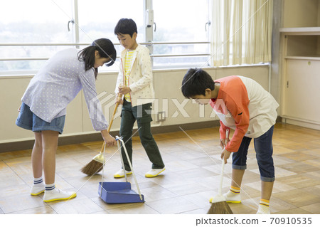 Elementary school student cleaning 70910535