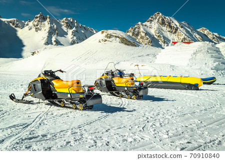 Group of yellow snowmobiles in mountains, Balea lake, Transylvania, Romania Group of yellow snowmobiles in mountains, Balea lake, Transylvania, Romania 70910840