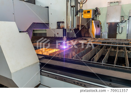 robot laser cutting metal on metalworking plant 70911357