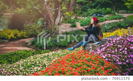woman travel nature in the flower garden. relax sitting on rocks and reading books In the midst of nature at national park doi Inthanon... woman travel nature in the flower garden. relax sitting on rocks and reading books In the midst of nature at national park doi Inthanon... 70911370