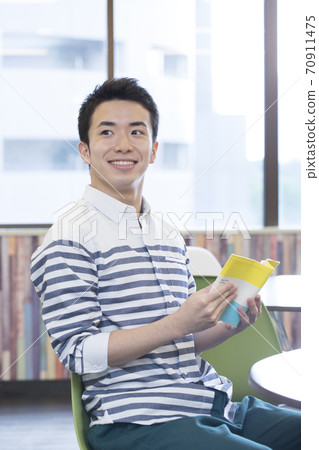 A man reading a book 70911475