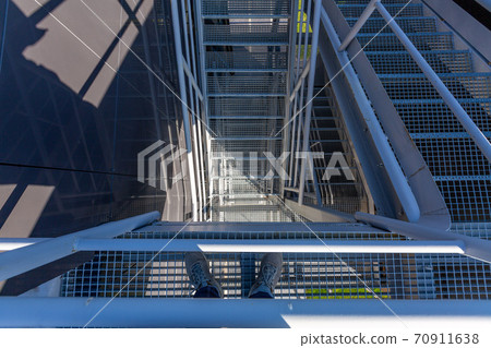 external metal staircase on a modern building. Solar lighting, summer day 70911638