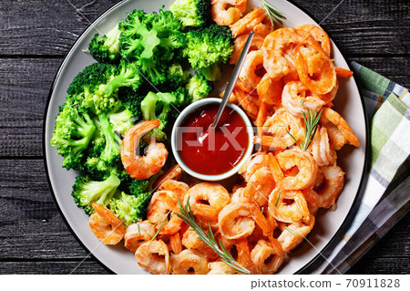 Garlic butter prawns with broccoli, top view Garlic butter prawns with broccoli, top view 70911828