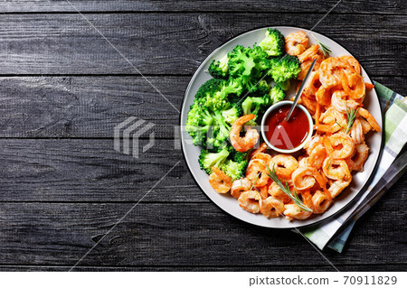 Garlic butter prawns with broccoli, top view Garlic butter prawns with broccoli, top view 70911829