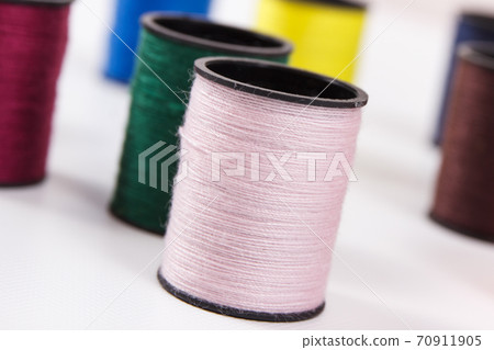 Colorful spools of thread. Accessories for needlework Colorful spools of thread. Accessories for needlework 70911905