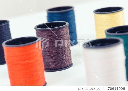 Spools of colorful thread as accessories for using in sewing. Spools of colorful thread as accessories for using in sewing. 70911906
