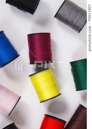 Spools of colorful thread as accessories for using in sewing. Spools of colorful thread as accessories for using in sewing. 70911907