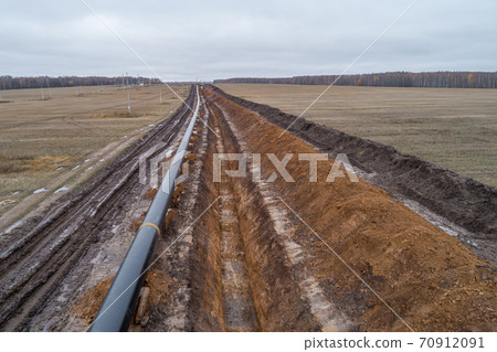 aerial photograph of the laying pipe of large diameter in clay soil. Autumn 70912091