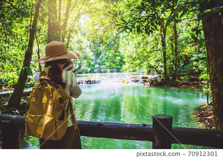 The girl travel take a photo of the Than Bok Thorni Waterfall National Park The girl travel take a photo of the Than Bok Thorni Waterfall National Park 70912301