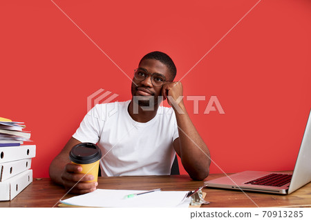 young stressed african male working with computer laptop in frustration, depression 70913285