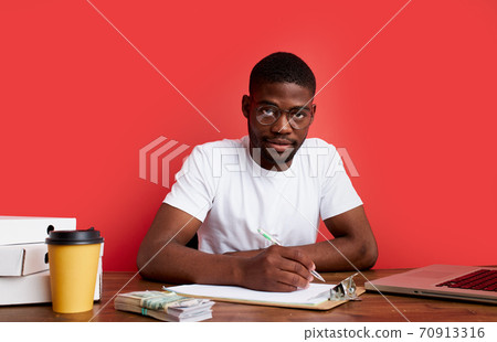 young stressed african male working with computer laptop in frustration, depression 70913316