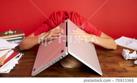 portrait of a young caucasian woman holding laptop computer on his head portrait of a young caucasian woman holding laptop computer on his head 70913368