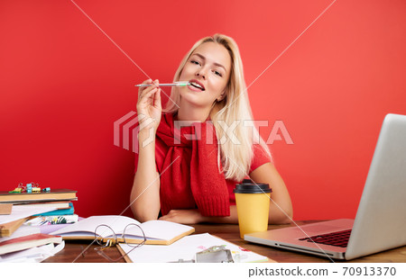 pretty caucasian female in contemplation, hold pen near mouth pretty caucasian female in contemplation, hold pen near mouth 70913370