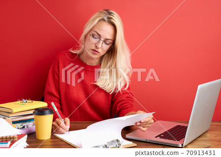 portrait of thoughtful caucasian female at work place portrait of thoughtful caucasian female at work place 70913431