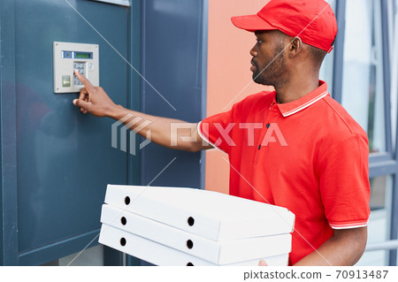 afro american courier calls the intercom to give orders food to clients 70913487