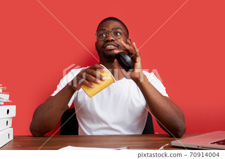 portrait of young african american working guy with cup of coffee in the office portrait of young african american working guy with cup of coffee in the office 70914004