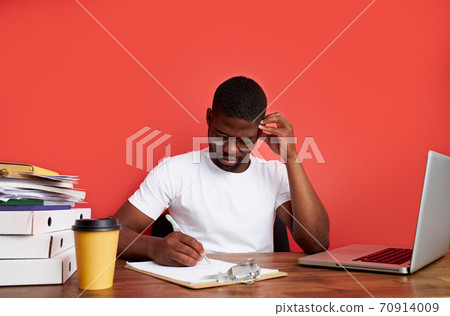 young stressed african male working with computer laptop in frustration, depression 70914009
