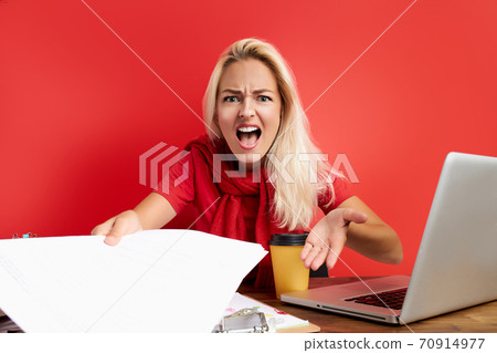 overworked unhappy and frustrated young caucasian woman in stress sitting at office desk overworked unhappy and frustrated young caucasian woman in stress sitting at office desk 70914977