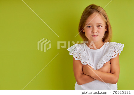 dissatisfied little girl look at camera, puff out 70915151