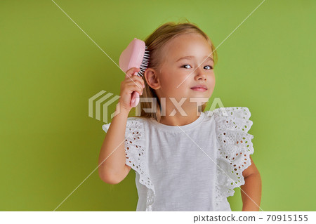 attractive caucasian girl combing hair isolated 70915155