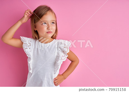 thoughtful little girl looking away, dreaming thoughtful little girl looking away, dreaming 70915158