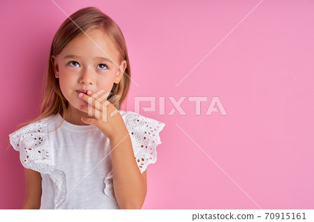 pretty caucasian little girl is dreaming about new toy 70915161