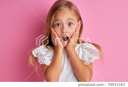 portrait of little caucasian girl in shock, she is surprised portrait of little caucasian girl in shock, she is surprised 70915163