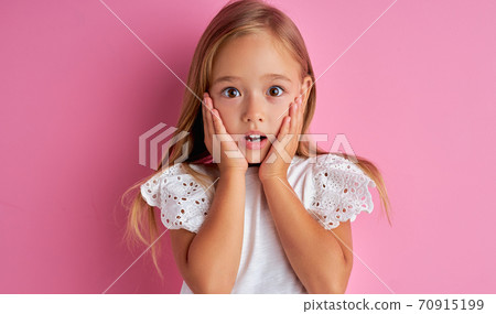 portrait of little caucasian girl in shock, she is surprised portrait of little caucasian girl in shock, she is surprised 70915199