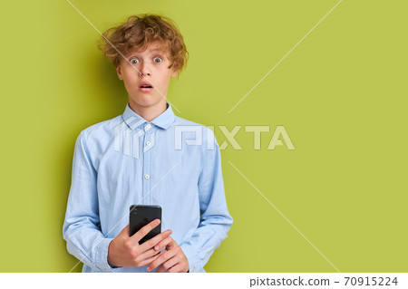 schoolboy is in shock by news on phone schoolboy is in shock by news on phone 70915224