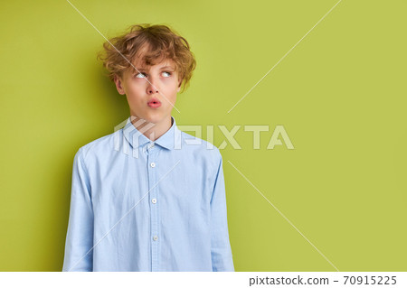thoughtful caucasian boy looks up and think thoughtful caucasian boy looks up and think 70915225