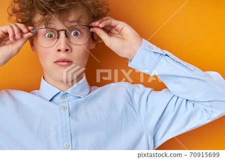 surprised wonk boy in eyeglasses look at camera in shock 70915699