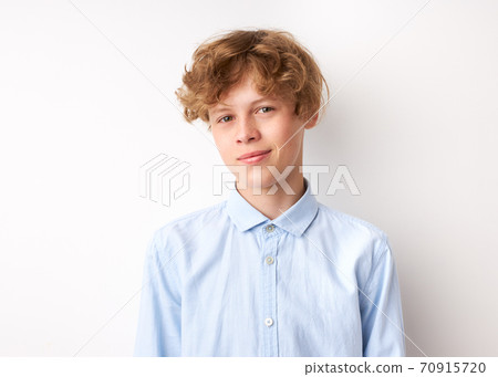 portrait of calm caucasian boy looking at camera portrait of calm caucasian boy looking at camera 70915720